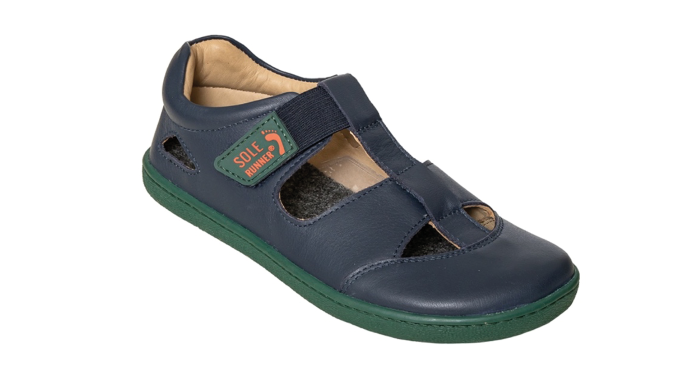 Kinder Barfußsandale, geschlossene Zehen und geschlossener Fersenbereich, zwei Klettverschlüsse und Riemen, flexible Sohle, einzelner Schuh, schräge Vorderansicht
