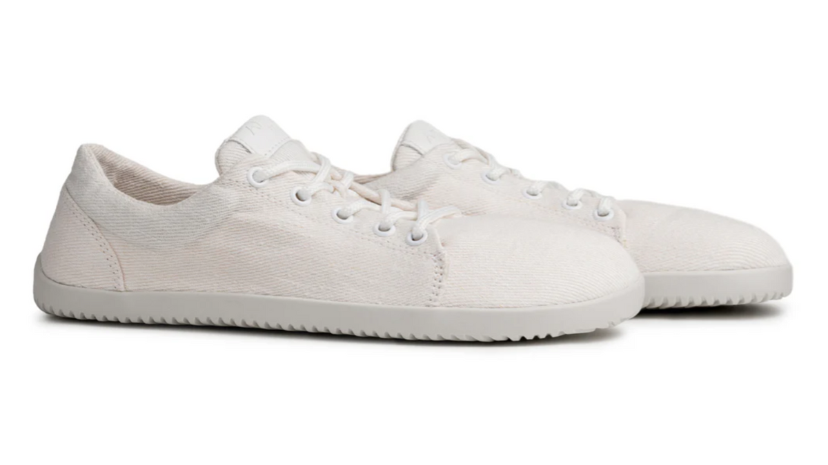 Barfußschuh, flache geschlossene Ausführung, schräge Vorderansicht als Paar. Runde Zehenform, bodennahe Bauweise.
