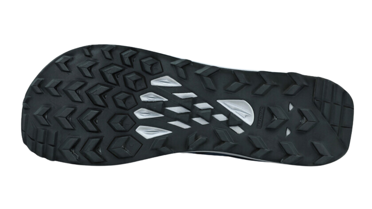 Trailrunningschuh, Ansicht von unten. Grob profilierte Laufsohle mit offenem Stollenmuster.