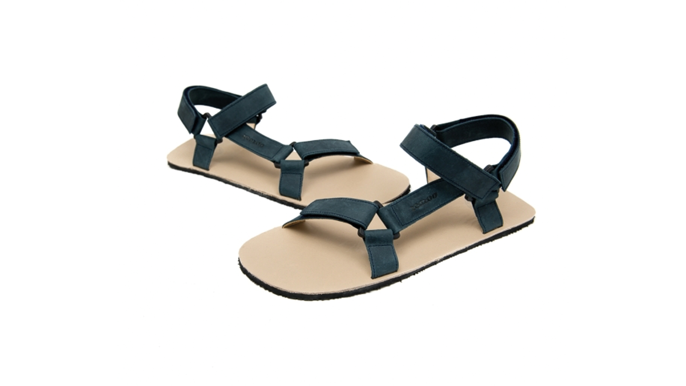 Barfußsandale für Erwachsene als einzelner Schuh, offene Zehen, offener Fersenbereich, Riemenkonstruktion mit Klettverschluss, Seitenansicht außen.