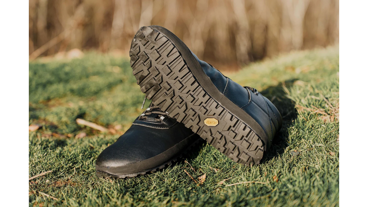 arfußschuhe im getragenen Zustand, Seitenansicht auf natürlichem Untergrund. Profilsohle vollständig sichtbar.