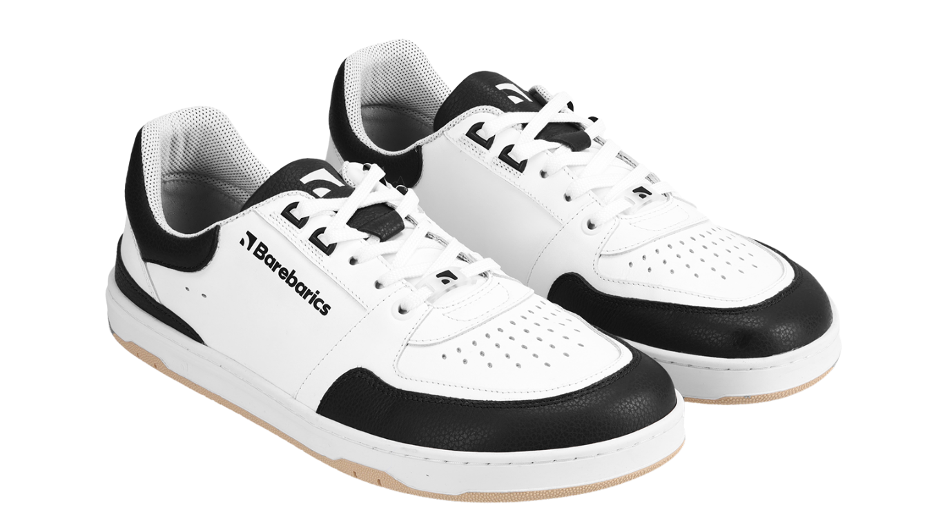 Barfußschuh für Erwachsene als Paar mit breiter Zehenbox, geschlossenem Zehenbereich, geschlossener Ferse, Schnürung, flacher flexibler Sohle, schräge Vorderansicht.