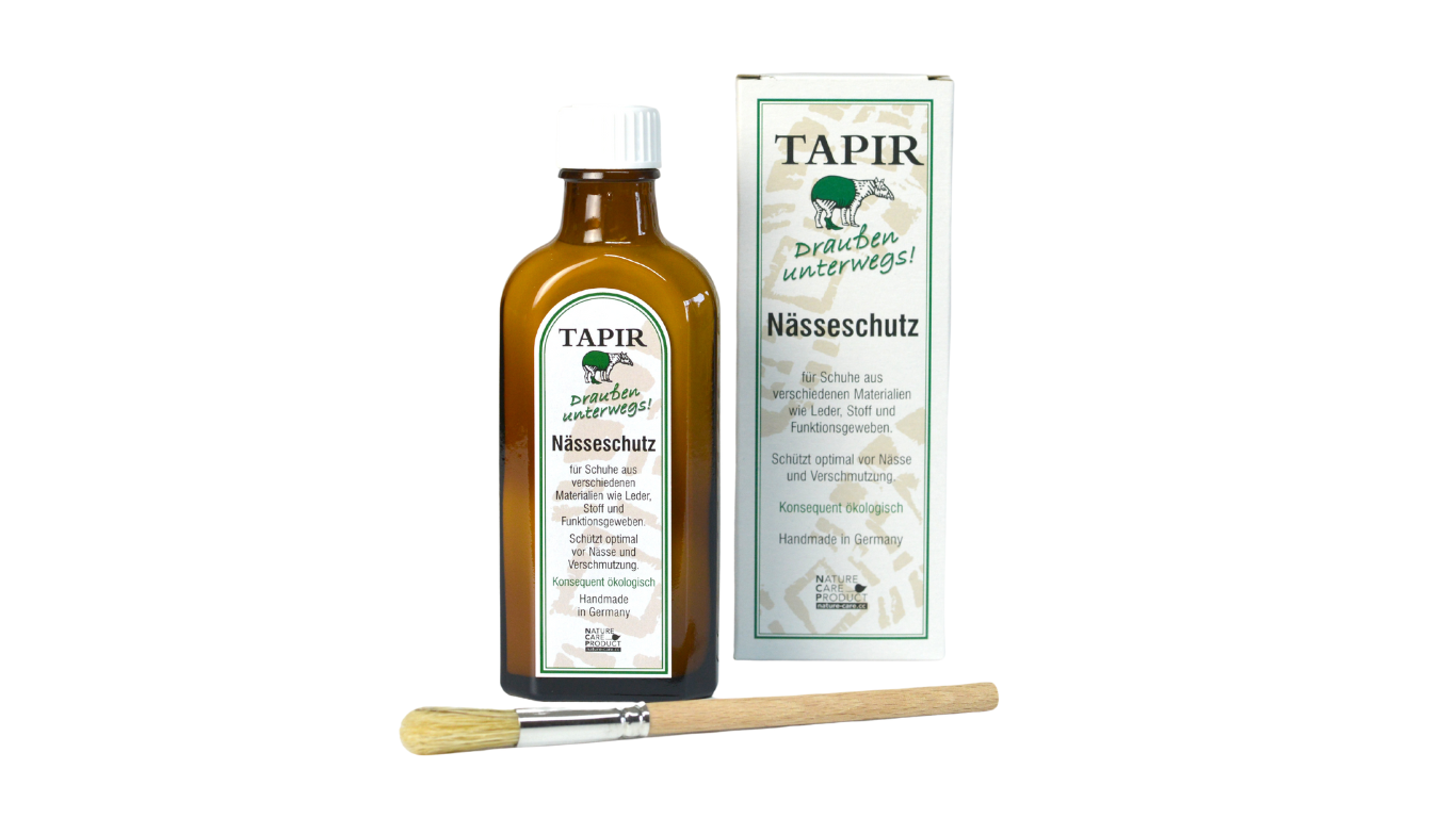Lederpflegemittel in Glasflasche mit Schraubverschluss, Verpackungskarton und Pinsel, schräge Vorderansicht