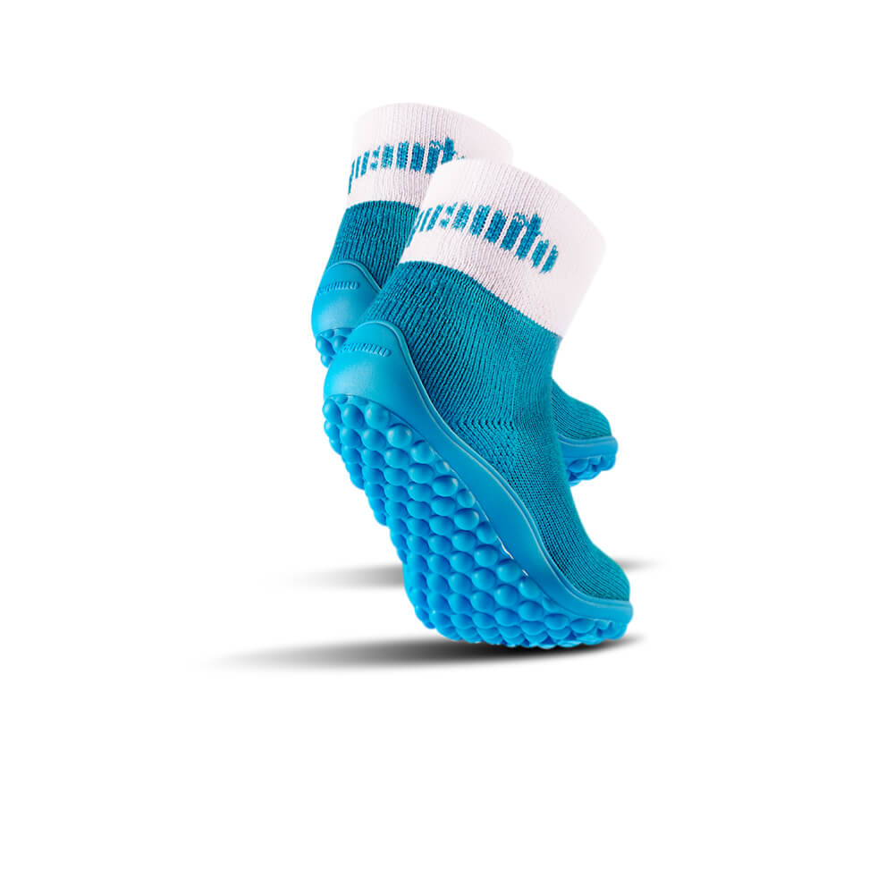 Barfußschuh mit geschlossener Zehenbox und geschlossenem Fersenbereich, elastischer Schaft ohne Verschluss, flexible Sohle mit runden Profilnoppen, schräge Ansicht von hinten als Paar